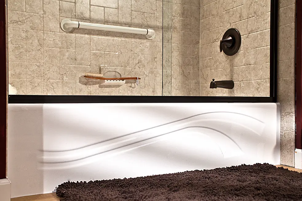 Wave bathtub with Brecchia finish and oil-rubbed bronze fixtures